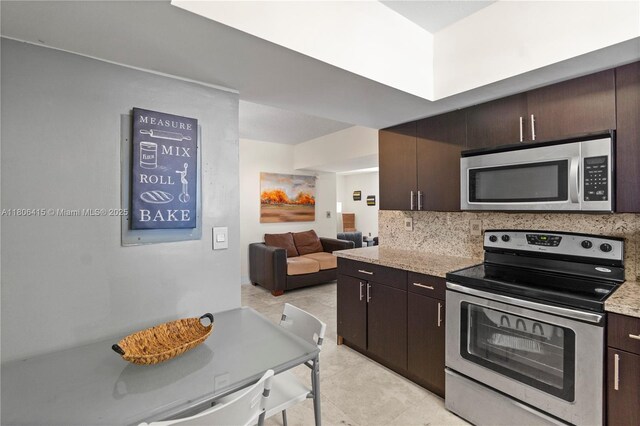 18181 NE 31st Ct Unit Ph07, Aventura, FL 33160 - kitchen featuring appliances with stainless steel finishes, dark brown cabinets, backsplash, light tile patterned floors, and open floor plan