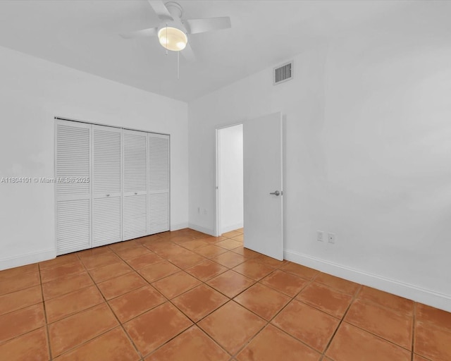 1218 Drexel Ave Unit 304, Miami Beach, FL 33139 - unfurnished bedroom featuring a closet, light tile patterned flooring, baseboards, and ceiling fan