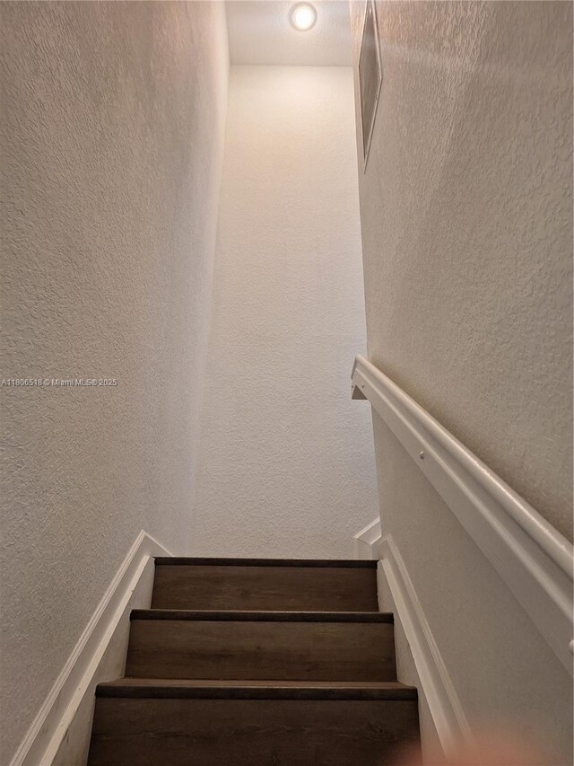 6621 Winfield Blvd Unit 1, Margate, FL 33063 - staircase featuring a textured wall
