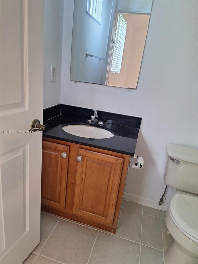 6621 Winfield Blvd Unit 1, Margate, FL 33063 - half bathroom featuring toilet, tile patterned floors, vanity, and baseboards