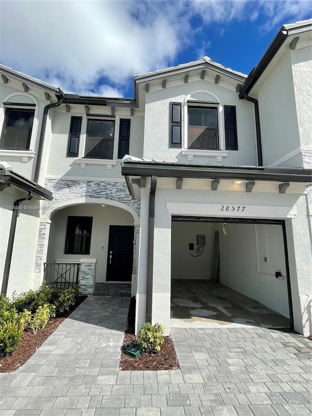 28577 SW 134th Ct, Homestead, FL 33033 - townhome / multi-family property featuring stucco siding, an attached garage, and covered porch