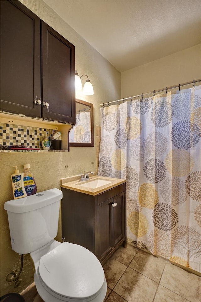 45 NW 127th St, North Miami, FL 33168 - bathroom with a textured wall, vanity, toilet, tile patterned flooring, and curtained shower