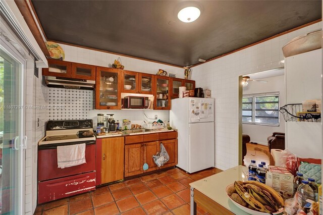 45 NW 127th St, North Miami, FL 33168 - kitchen featuring freestanding refrigerator, electric range, plenty of natural light, and under cabinet range hood