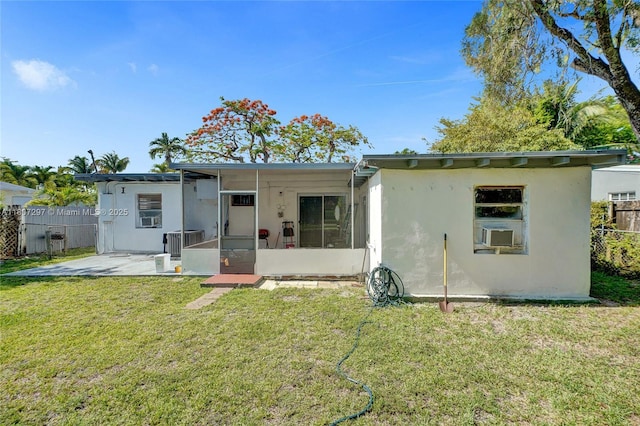 45 NW 127th St, North Miami, FL 33168 - rear view of property with a sunroom, central AC, stucco siding, cooling unit, and a patio area