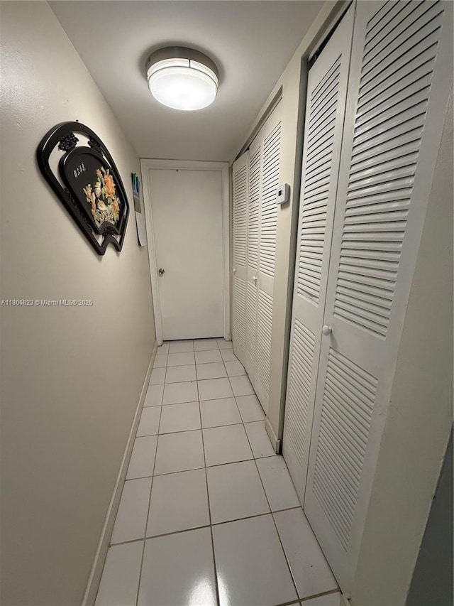 12209 SW 14th Ln Unit 1101, Miami, FL 33184 - corridor featuring baseboards and light tile patterned flooring