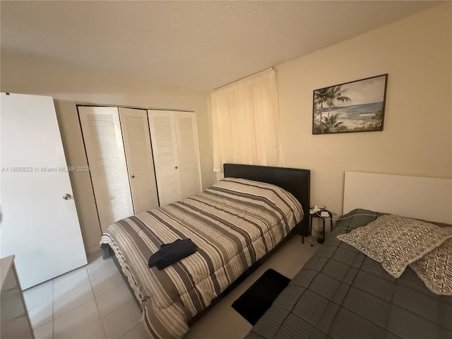 12209 SW 14th Ln Unit 1101, Miami, FL 33184 - bedroom featuring a closet and tile patterned flooring