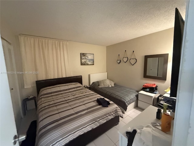 12209 SW 14th Ln Unit 1101, Miami, FL 33184 - bedroom featuring tile patterned flooring and a textured ceiling