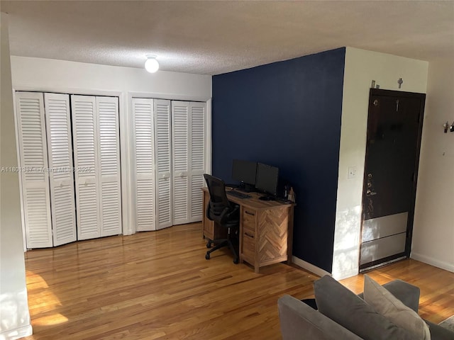 1100 Salzedo St Unit 3A, Coral Gables, FL 33134 - home office with light wood-style floors, baseboards, and a textured ceiling