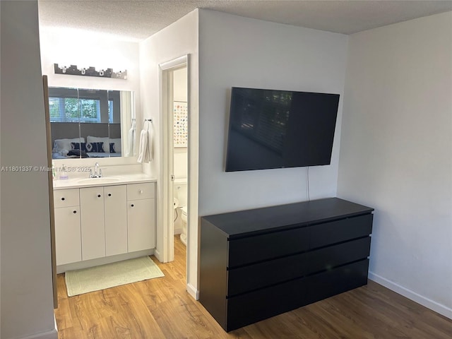 1100 Salzedo St Unit 3A, Coral Gables, FL 33134 - unfurnished living room featuring a sink, light wood-style floors, and baseboards