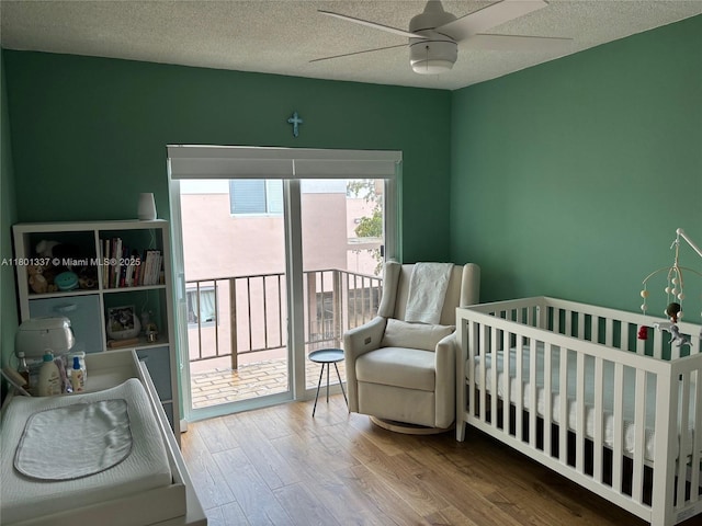 1100 Salzedo St Unit 3A, Coral Gables, FL 33134 - bedroom featuring wood finished floors, a textured ceiling, a ceiling fan, and access to outside