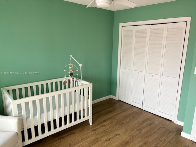 1100 Salzedo St Unit 3A, Coral Gables, FL 33134 - bedroom with dark wood finished floors, baseboards, a crib, and a closet