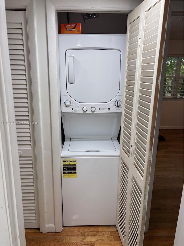 1100 Salzedo St Unit 3A, Coral Gables, FL 33134 - laundry room with stacked washing machine and dryer and light wood-type flooring