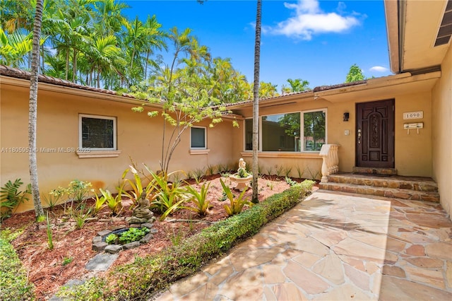 1090 Meadowlark Ave, Miami Springs, FL 33166 - doorway to property with stucco siding