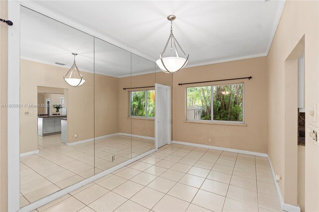 1090 Meadowlark Ave, Miami Springs, FL 33166 - empty room with tile patterned floors and ornamental molding