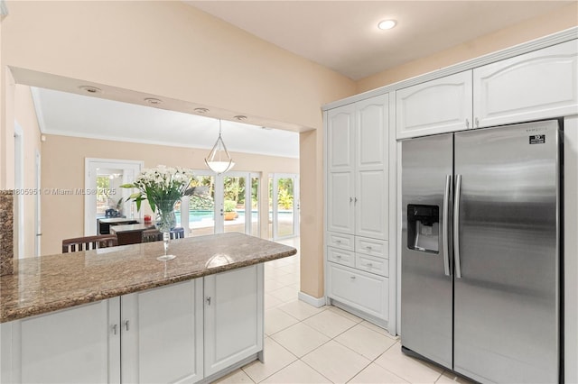 1090 Meadowlark Ave, Miami Springs, FL 33166 - kitchen featuring stainless steel fridge, white cabinetry, dark stone countertops, french doors, and light tile patterned flooring