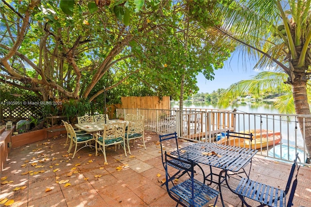 1090 Meadowlark Ave, Miami Springs, FL 33166 - view of patio / terrace featuring outdoor dining area and a water view