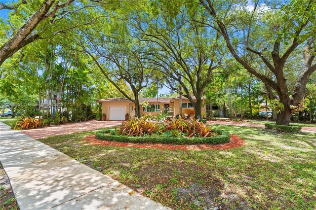 1090 Meadowlark Ave, Miami Springs, FL 33166 - ranch-style home featuring driveway, an attached garage, and stucco siding