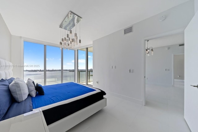 2900 NE 7th Ave Unit 3605, Miami, FL 33137 - bedroom featuring a chandelier, a water view, baseboards, and light tile patterned floors