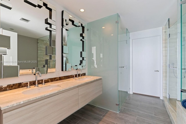 2900 NE 7th Ave Unit 3605, Miami, FL 33137 - bathroom with a stall shower, double vanity, wood tiled floors, and recessed lighting