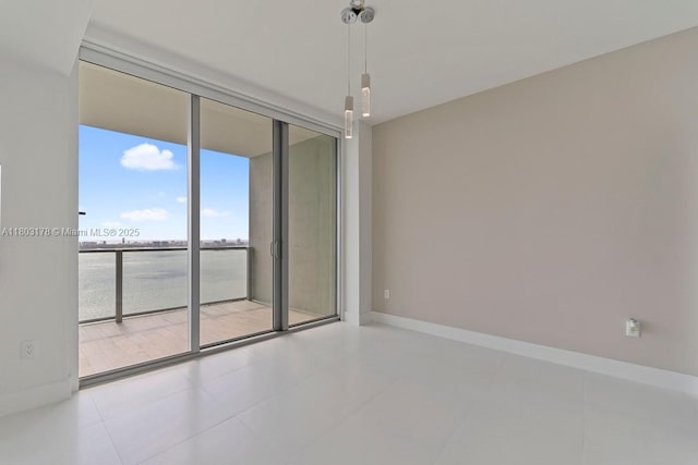 2900 NE 7th Ave Unit 3605, Miami, FL 33137 - tiled empty room with a wall of windows, baseboards, and a water view