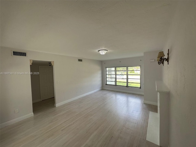 3621 Ponce De Leon Blvd, Coral Gables, FL 33134 - spare room with light wood-style floors, baseboards, and a textured ceiling