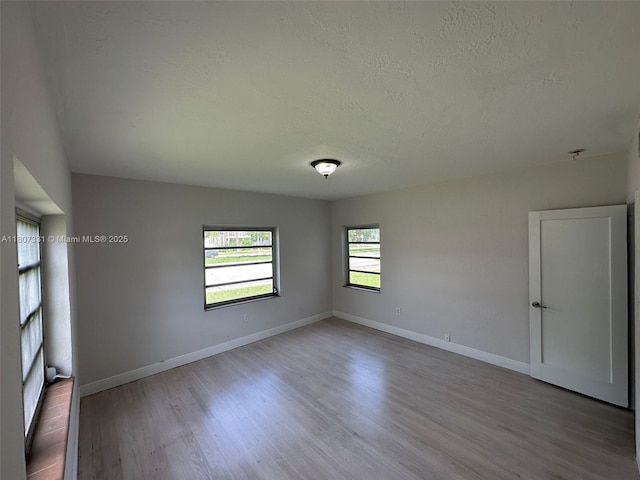 3621 Ponce De Leon Blvd, Coral Gables, FL 33134 - unfurnished room featuring wood finished floors, a textured ceiling, and baseboards