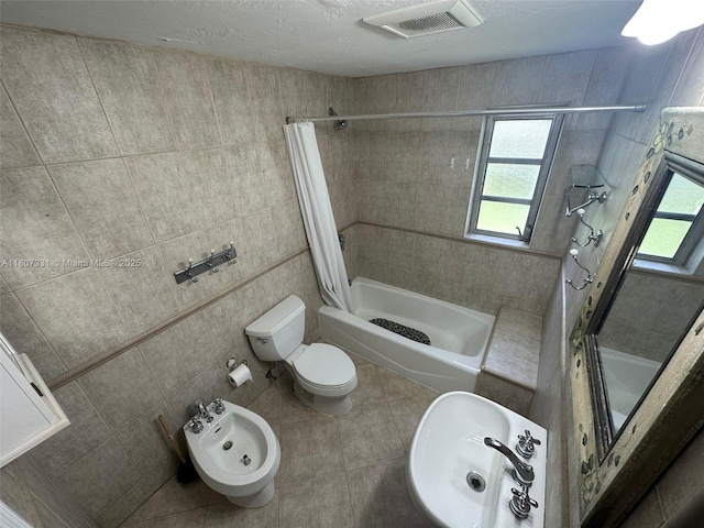3621 Ponce De Leon Blvd, Coral Gables, FL 33134 - full bath featuring healthy amount of natural light, tile patterned flooring, a bidet, shower / bath combo with shower curtain, and tile walls