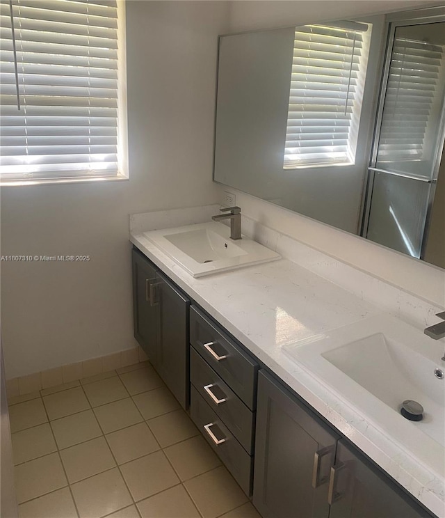 3107 Kingston Ct, West Palm Beach, FL 33409 - full bath with double vanity, tile patterned flooring, and baseboards