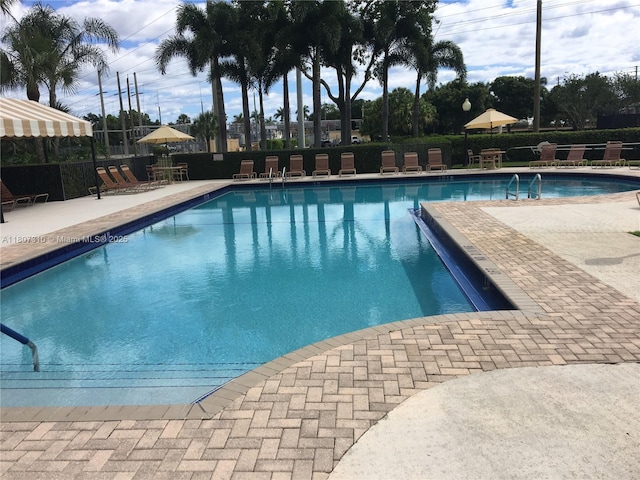 3107 Kingston Ct, West Palm Beach, FL 33409 - community pool featuring a patio area