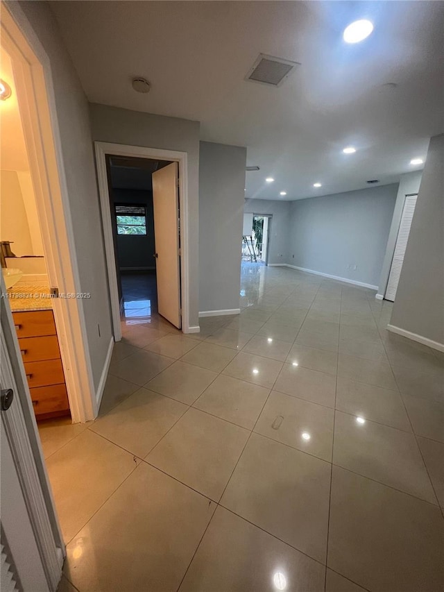 7368 SW 82nd St Unit E215, Miami, FL 33143 - hall featuring light tile patterned flooring, baseboards, healthy amount of natural light, and recessed lighting