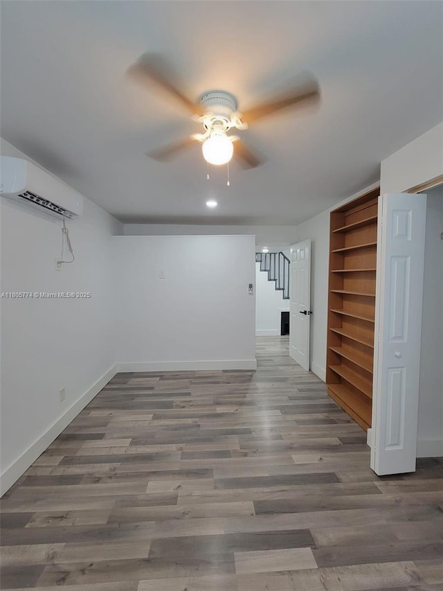 15225 SW 235th St, Homestead, FL 33032 - unfurnished room featuring ceiling fan, baseboards, stairs, a wall mounted air conditioner, and wood finished floors