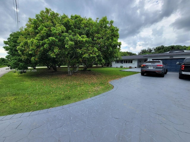 15225 SW 235th St, Homestead, FL 33032 - view of front of home featuring concrete driveway, a front lawn, and a garage