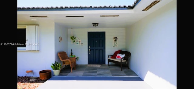 15225 SW 235th St, Homestead, FL 33032 - property entrance featuring a porch and stucco siding