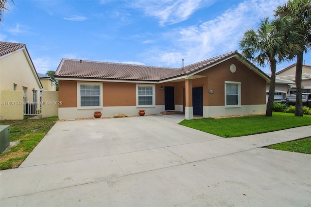 19171 NW 89th Ct, Hialeah, FL 33018 - ranch-style house featuring a tiled roof, stucco siding, a front yard, and concrete driveway