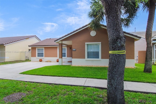 19171 NW 89th Ct, Hialeah, FL 33018 - view of front facade with stucco siding, a tile roof, a front lawn, and driveway