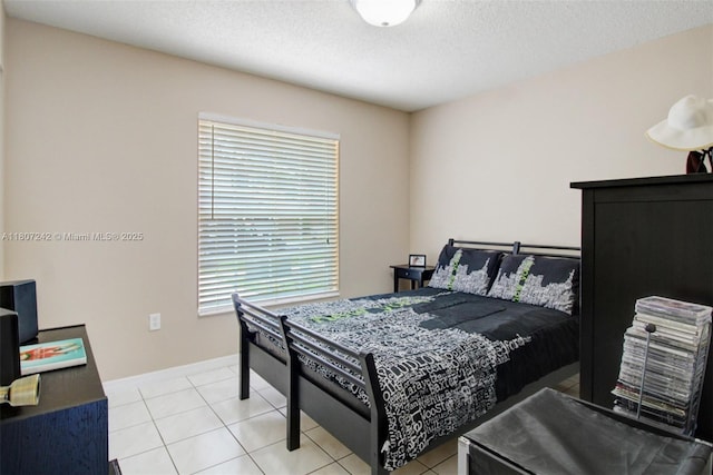 19171 NW 89th Ct, Hialeah, FL 33018 - bedroom featuring multiple windows, baseboards, a textured ceiling, and light tile patterned floors