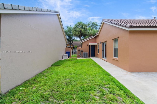 19171 NW 89th Ct, Hialeah, FL 33018 - view of grassy yard featuring a gate and central air condition unit