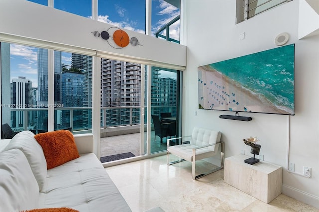 41 SE 5th St Unit 2008, Miami, FL 33131 - tiled living room featuring baseboards, a towering ceiling, and a view of city