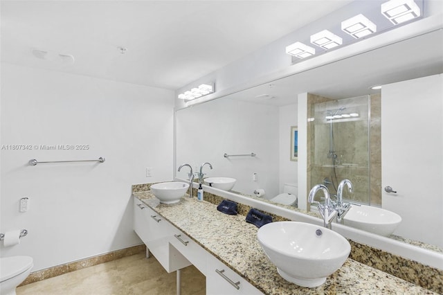 41 SE 5th St Unit 2008, Miami, FL 33131 - bathroom with toilet, a stall shower, baseboards, double vanity, and tile patterned flooring