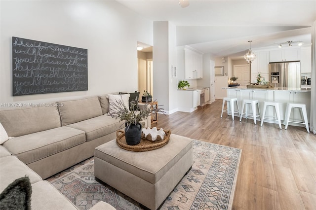 15828 S Ashby Field Rd S, Davie, FL 33331 - living room with vaulted ceiling, light wood-style flooring, a chandelier, and baseboards