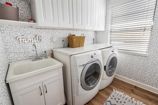 15828 S Ashby Field Rd S, Davie, FL 33331 - washroom with washer and clothes dryer, wood finished floors, cabinet space, baseboards, and wallpapered walls