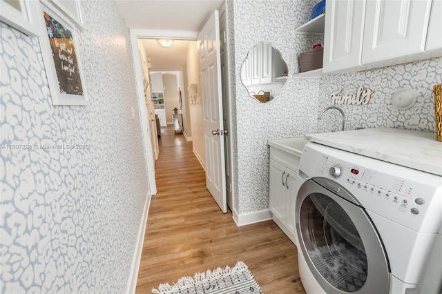 15828 S Ashby Field Rd S, Davie, FL 33331 - washroom featuring washer / dryer, wallpapered walls, cabinet space, light wood-style floors, and baseboards