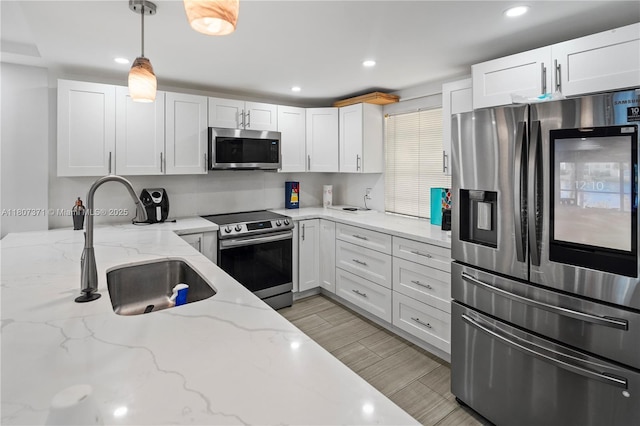 141 SE 3rd Ave Unit 101, Dania Beach, FL 33004 - kitchen with stainless steel appliances, a sink, white cabinets, and recessed lighting