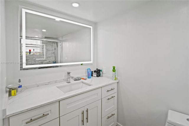 141 SE 3rd Ave Unit 101, Dania Beach, FL 33004 - bathroom with vanity, toilet, a shower stall, and recessed lighting