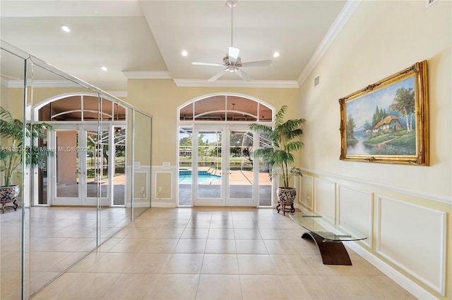 8281 SW 84th Ter, Miami, FL 33143 - doorway featuring french doors, a decorative wall, ornamental molding, tile patterned floors, and a wainscoted wall
