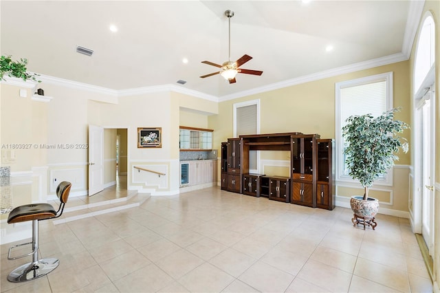 8281 SW 84th Ter, Miami, FL 33143 - unfurnished living room featuring a ceiling fan, ornamental molding, tile patterned flooring, a decorative wall, and recessed lighting