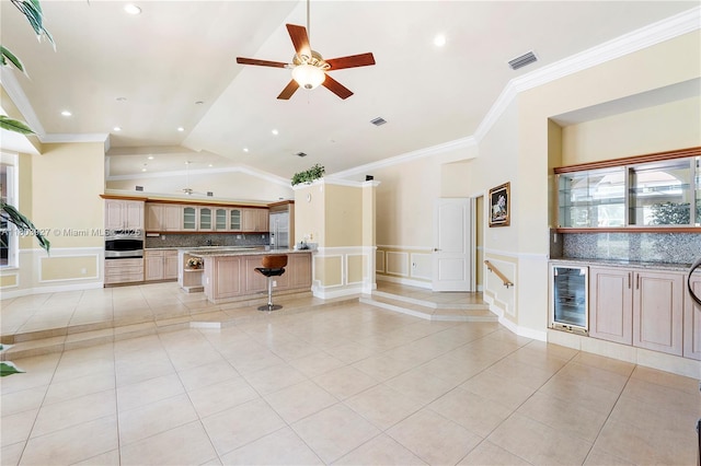 8281 SW 84th Ter, Miami, FL 33143 - kitchen featuring stainless steel oven, beverage cooler, a breakfast bar, light tile patterned floors, and crown molding