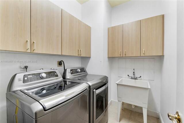 8281 SW 84th Ter, Miami, FL 33143 - washroom featuring cabinet space, washing machine and dryer, and light tile patterned floors