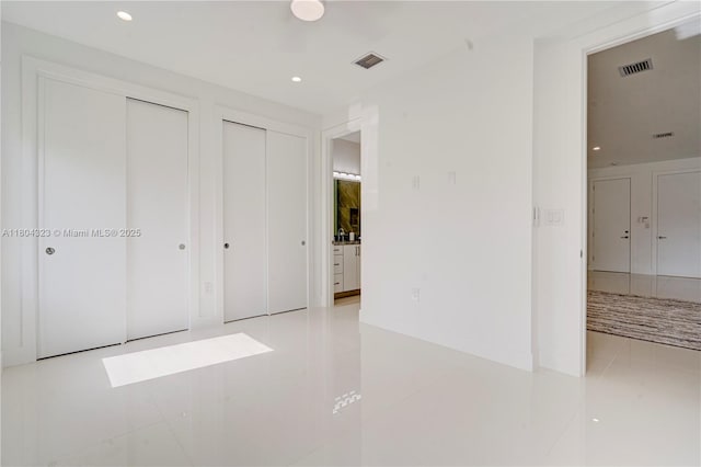 1805 NW 22nd Ct, Miami, FL 33125 - unfurnished bedroom featuring multiple closets, recessed lighting, and tile patterned flooring