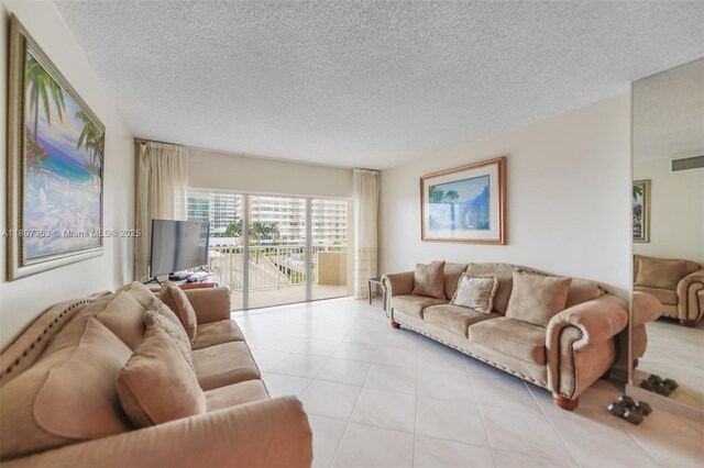 1950 S Ocean Dr Unit 3L, Hallandale Beach, FL 33009 - living room featuring a textured ceiling and light tile patterned floors